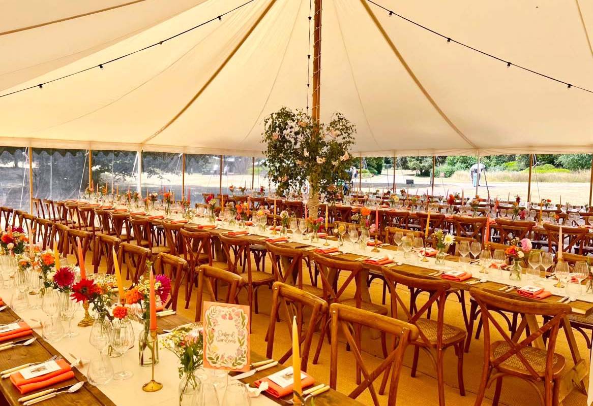 Trestle tables and cross back chairs dressed for a party