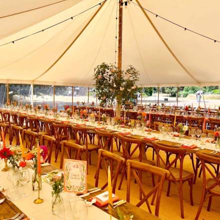 Trestle tables and cross back chairs dressed for a party