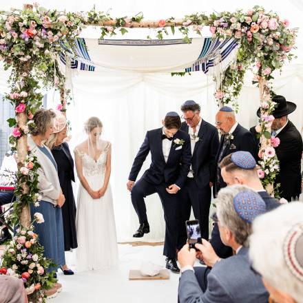 Groom stamping on glass as per Jewish tradition