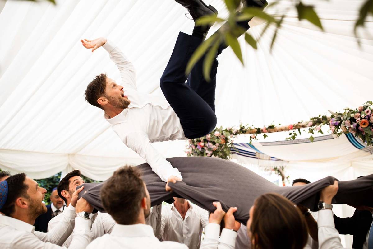 Groom thrown up high as per Jewish tradition