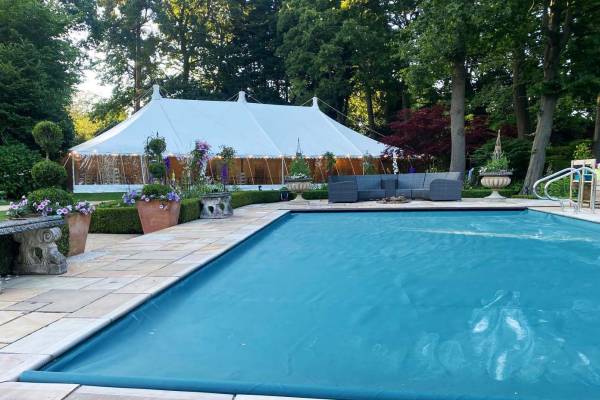 Large traditional marquee by a swimming pool